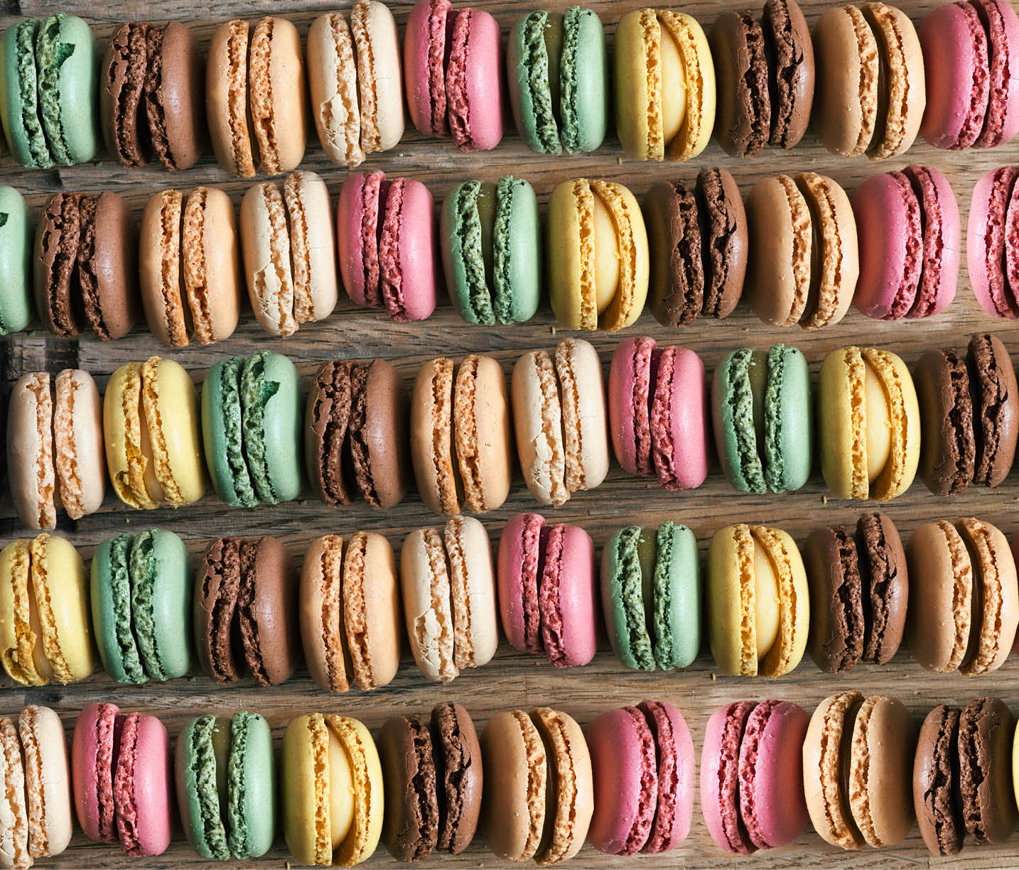 Colorful macarons background aerial or top view on wooden table